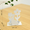 White metal Easter bunny candle holder with floral silhouette on a wooden table - Rabbit Candle Holder