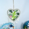 Detail of heart wooden ornament with green lizard, Ibiza text and tropical palm leaves - Gecko