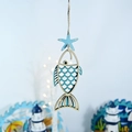 Detail of wooden ocean-style hanging ornament with starfish and fish-shaped pendants - Fish