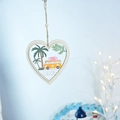 Macro detail of a heart-shaped wooden Ibiza ornament with palm tree and camper van - Car