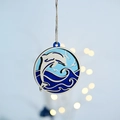 Detail of multi-layered wooden ocean ornament with carved dolphin and waves scene - Whale