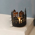 Black metal hollow city silhouette candle holder with a warm tea light inside - House