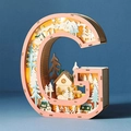 Close-up of wooden letter G LED light with reindeer and forest silhouette cutout - Letter G