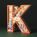 Detail of wooden letter K Christmas light with multi-layer carved winter scene - Letter K