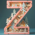 Close-up of pink wooden LED letter Z with warm lighting and laser-cut winter scene details - Letter Z