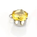 Macro shot of yellow multifaceted round gemstone pendant with silver claw setting - 8mm / Yellow