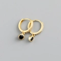 Macro view of gold hoop earrings with small zircon stones and black gemstone pendants - Black Zirconia (Gold Base)