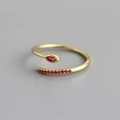 Macro detail of gold snake ring featuring a marquise red zircon and stone-set tail - Adjustable Open / Red Stone Gold