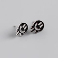 Detailed view of S925 sterling silver stud earrings featuring black enamel dripping smiley faces - 925 Silver / Black (Platinum Plated)