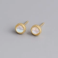 Macro shot of S925 silver stud earrings featuring faux moonstone and beaded edges - Gold