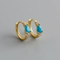 Detailed macro of gold hoop earrings with pear-shaped turquoise and cubic zirconia accents - Style B (Gold)