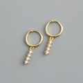 Macro view of gold hoop earrings with four white sparkling zircon linear drop accents - 925 Silver / White Zirconia (Gold)