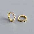 Detailed macro view of S925 engraved hallmark on diamond-cut gold plated hoop earrings - 925 Silver / Gold