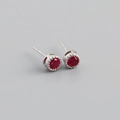 Close-up of S925 silver stud earrings featuring round red zircons in a crown setting - 925 Silver / Ruby Red (Silver)