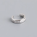 Detailed macro view of S925 sterling silver ear cuff with square-cut cubic zirconia stones - Silver Tone