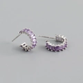 Macro detail of silver C-shaped earrings with purple rectangular baguette cubic zirconia stones - Purple Zircon (Silver Tone)