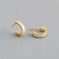 Detail view of gold C-shape stud earrings featuring rectangle-cut clear cubic zirconia stones - White Zirconia (Gold Tone)