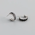 Detailed close-up of S925 silver stamp and black zircon inlay on C-shaped stud earrings - Black Zirconia (Silver Tone)
