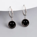 Macro shot of S925 sterling silver hoop earrings featuring black enamel smiley face charms - Black (Platinum)