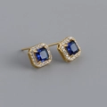 Macro view of square blue gemstone earrings with white diamond halo and gold pins - Blue Stone (Gold)