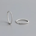 Detailed view of S925 sterling silver hoop earrings with a continuous bead design texture - 16mm / 925 Silver / White Gold