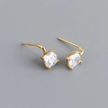 Macro shot of S925 sterling silver stamp and square-cut zircon studs in gold finish - Clear White (Gold)