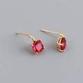 Detail of cushion-cut ruby red zircon stud earrings with gold plating on grey background - Ruby Red (Gold)