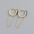 Detailed macro view of gold-plated silver chain fringe earrings with black zircon stones - 925 Silver / Black Stone Gold Color