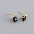 Close-up of gold S925 silver stud earrings featuring square-cut black zircon stones - Black Zirconia (Gold)