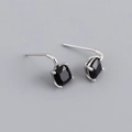 Macro shot of silver stud earrings featuring black square-cut cubic zirconia in prong setting - Black Zirconia (Silver)