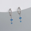 Macro shot of S925 silver earrings with light blue zircons and shimmering accents - 925 Silver / Light Blue (Silver Tone)