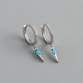 Detail of silver hoop earrings with turquoise stones and cone pendants in close-up view - 925 Silver / Turquoise Zircon (White Gold Color)
