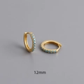 Detail showing 12mm gold huggie hoop earrings with turquoise pavé zircons on grey background - 925 Silver / 12mm / Gold
