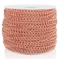 Macro view of rose gold stainless steel extender chain on a roll for DIY jewelry making - 0.5x2.5x3.5mm / Rose Gold