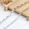 Macro shot of two different gauges of rectangular stainless steel chain links - 3mm Wide Square Box Chain / Steel