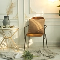 Modern square teddy fleece cushion in camel brown color on a dark wood chair - Camel