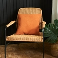Minimalist orange embossed square pillowcase with geometric pattern on a rattan chair - Orange
