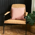 Pink square pillow cover with embossed diamond texture on a stylish rattan chair - Lotus Pink