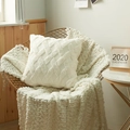 White geometric plush pillow cover with textured 3D woven pattern on golden chair - Cream