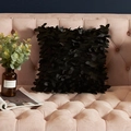 Black decorative pillow cover with 3D handmade leaves on a pink velvet sofa - Black