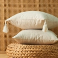 Set of two beige linen textured decorative pillowcases with cotton tassels on straw mat - 45x45cm (With 400g Non-woven Cotton Core) / White with Tassel