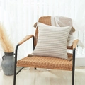 Beige and light brown striped linen pillow cover with tassels on a woven chair - Beige Striped