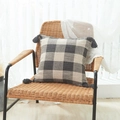 Linen textured gray and cream plaid cushion cover with tassels on a chair - Taupe Checkered