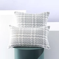Two-piece gray and white woven lumbar pillow covers on decorative geometric stands - City Gray
