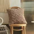 Brown plush throw pillow cover with 3D geometric tufted pattern on a wooden chair - Khaki