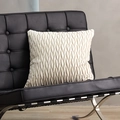 Square cream velvet pillowcase with accordion pleats on a black leather chair - Asparagus White