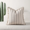 Bohemian cream cushion cover with black stripes and fringe edges on a white sofa - Black