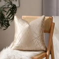 Champagne gold geometric throw pillow cover with high-precision piping on a cozy chair - Gold Line Spiral
