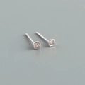 Macro shot of minimalist square silver earrings featuring small pink cubic zirconia stones - Square Pink Zirconia (Platinum) / 925 Silver