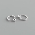 Macro detail of 925 sterling silver C-shaped hoop earrings with polished metal bead ends - Round Bead Style (Style 2) / White Gold